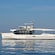 A passenger boat with a French flag sailing on serene waters